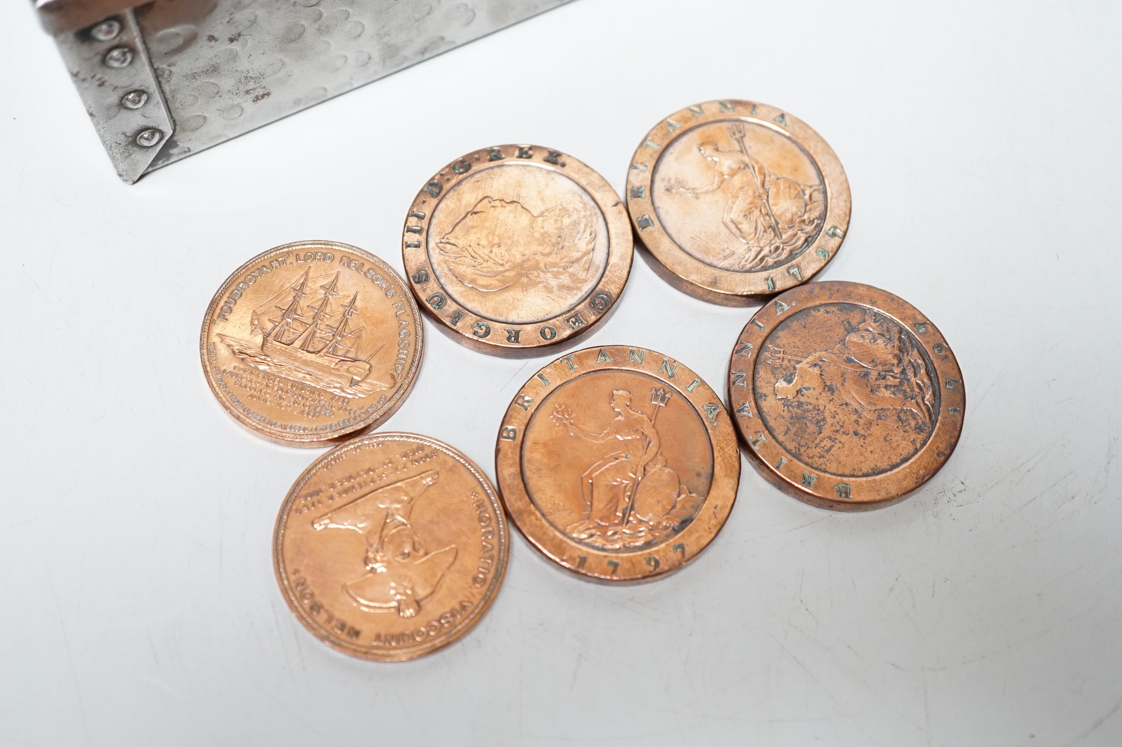 A metal and brass money box (locked) and contents together with 1797 twopence copper coins, polished